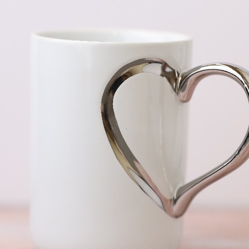 WHITE MUG WITH SILVER HEART HANDLE